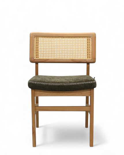 Close-up of a wooden chair with a woven rattan backrest and a textured green upholstered seat.