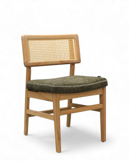 Close-up of a wooden chair with a woven rattan backrest and a textured green upholstered seat.
