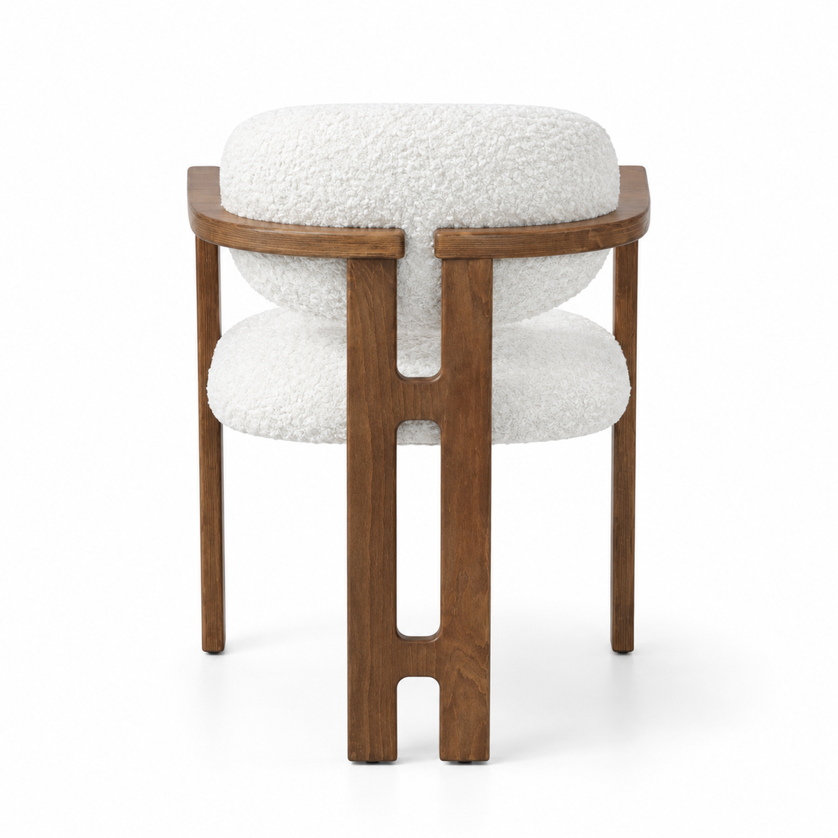 A modern accent chair featuring a warm brown wooden frame with a unique cutout design on the legs, paired with plush white bouclé fabric cushions on the seat and backrest, shown against a solid white background.