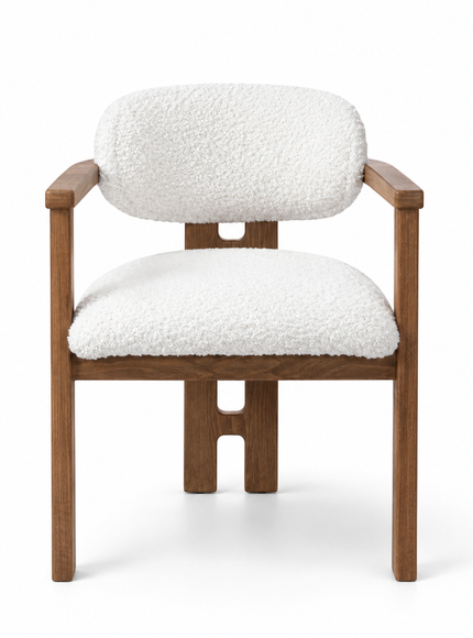 A modern accent chair featuring a warm brown wooden frame with a unique cutout design on the legs, paired with plush white bouclé fabric cushions on the seat and backrest, shown against a solid white background.