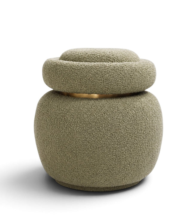 A modern textured pouf or small stool with a matching lid, upholstered in a bouclé-like fabric in a muted sage green color, featuring a thin gold metallic accent ring around the middle, set against a plain white background.