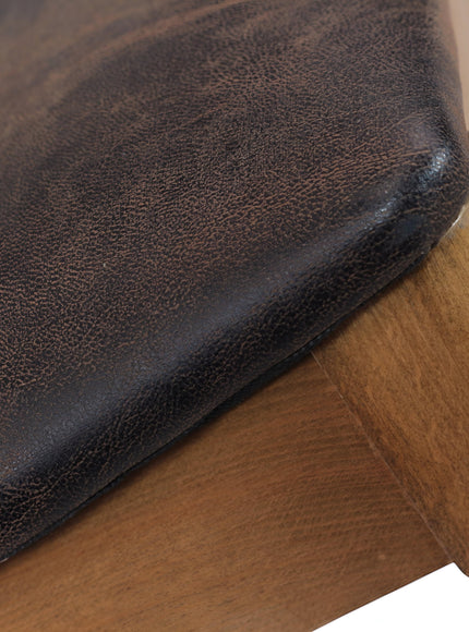 Close-up of the Vaya Home Albero dining chair showing the brown upholstered seat and wood frame detail.