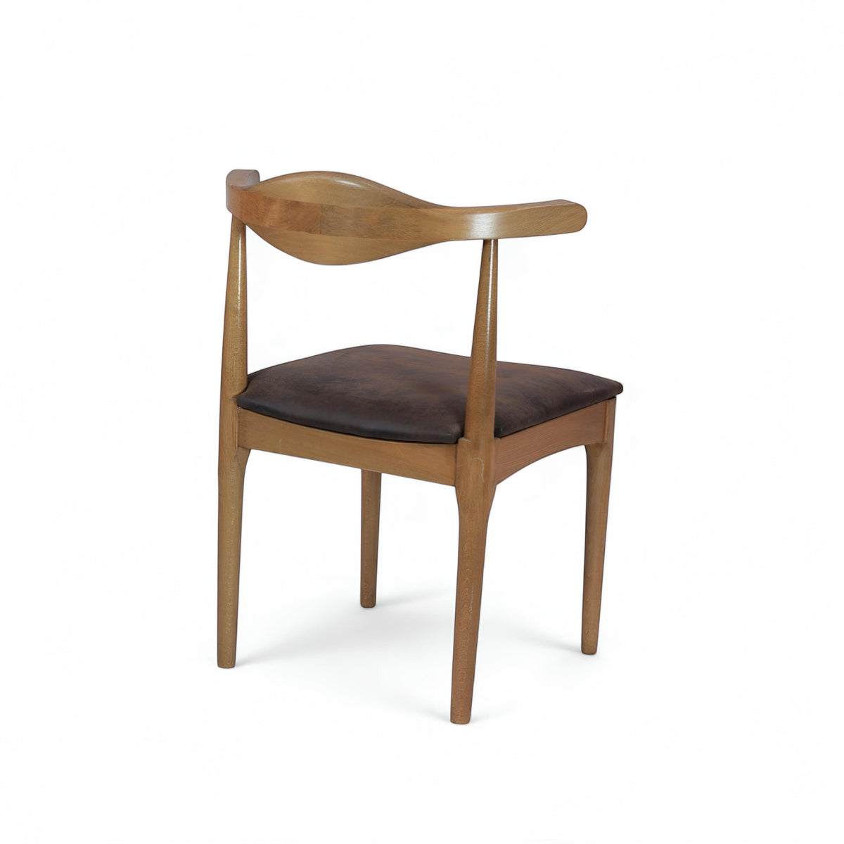 Front angled view of the Vaya Home Albero dining chair featuring a sculpted wood backrest and brown upholstered seat.