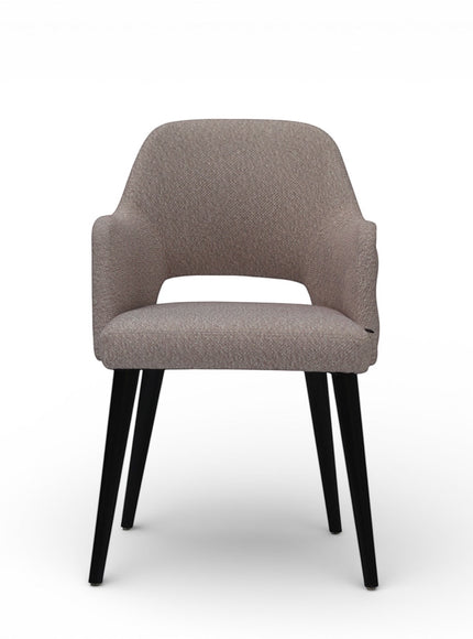 Front view of the Vaya Home Alt dining chair with beige upholstery, integrated arms, and black tapered legs.