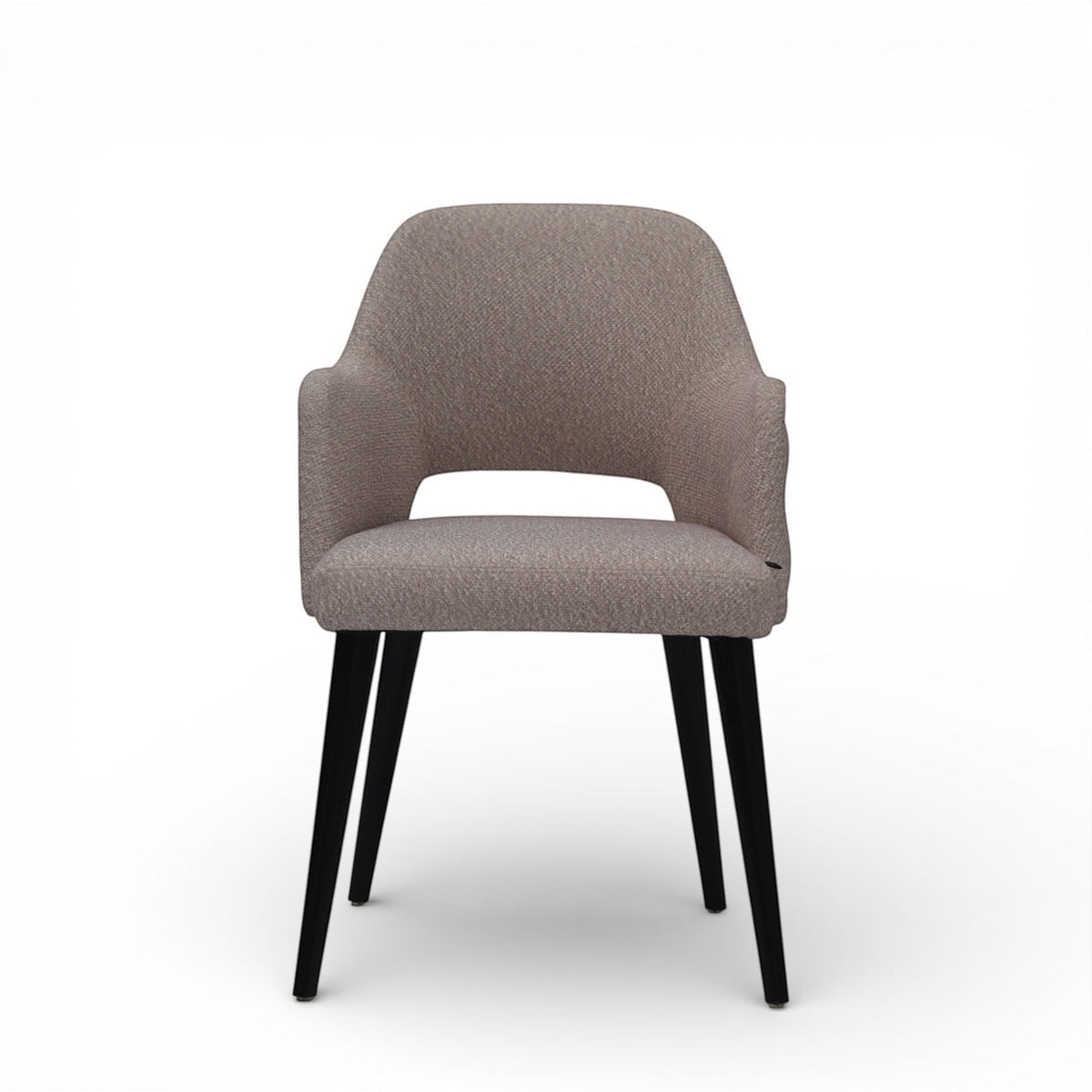 Front view of the Vaya Home Alt dining chair with beige upholstery, integrated arms, and black tapered legs.