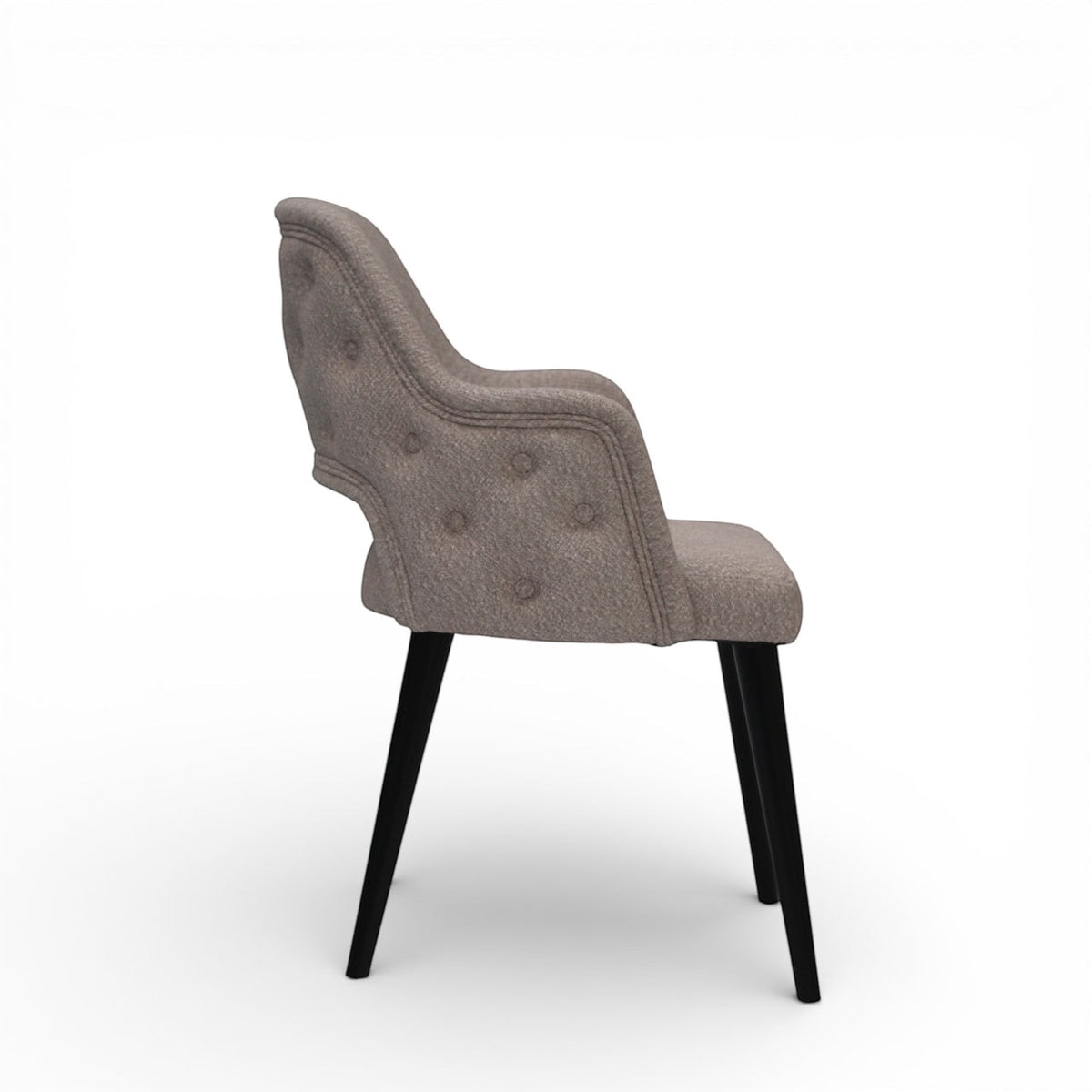 Side view of the Vaya Home Alt dining chair featuring beige upholstery, curved arms, button-tufted outer back, and black tapered legs.