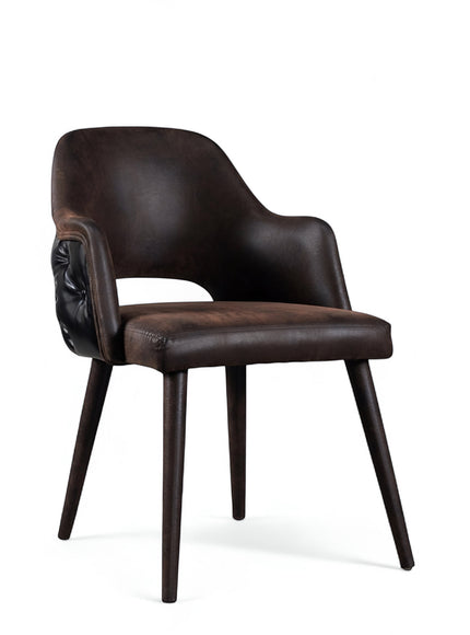 Front angled view of the Vaya Home Alt dining chair with dark brown leather upholstery, integrated arms, and tapered wood legs.