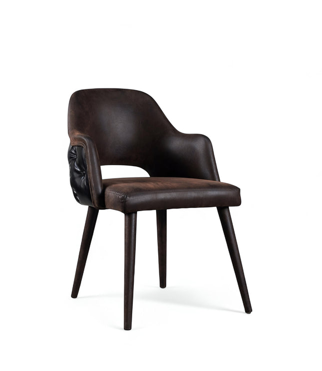 Front angled view of the Vaya Home Alt dining chair with dark brown leather upholstery, integrated arms, and tapered wood legs.