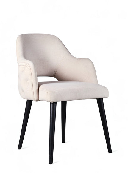 Front angled view of the Vaya Home Alt dining chair with white upholstery, integrated arms, and black tapered legs.