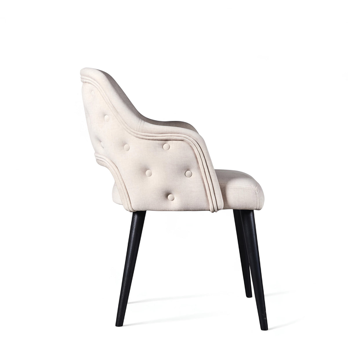 Side rear view of the Vaya Home Alt dining chair featuring white upholstery, a curved button-tufted back, and black tapered legs.