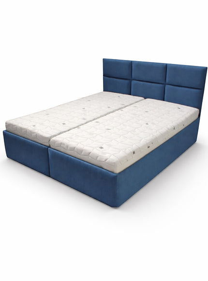 Angled view of the Vaya Home Alturo upholstered bed with blue fabric frame and paneled headboard.