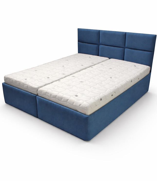 Angled view of the Vaya Home Alturo upholstered bed with blue fabric frame and paneled headboard.