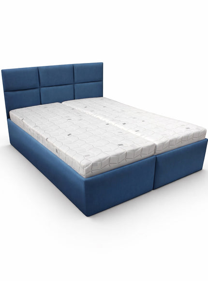 Side angled view of the Vaya Home Alturo upholstered bed with blue fabric upholstery and paneled headboard.