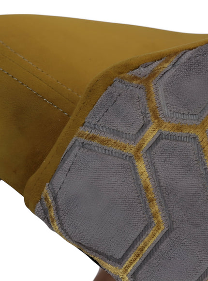Close-up of the Vaya Home Alveare dining chair showing gray geometric patterned upholstery and yellow seat detail.