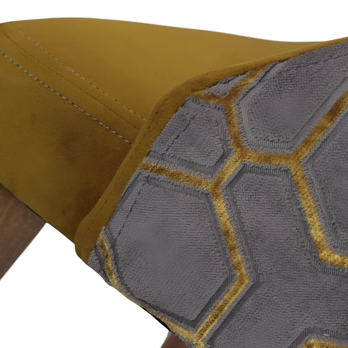Close-up of the Vaya Home Alveare dining chair showing gray geometric patterned upholstery and yellow seat detail.