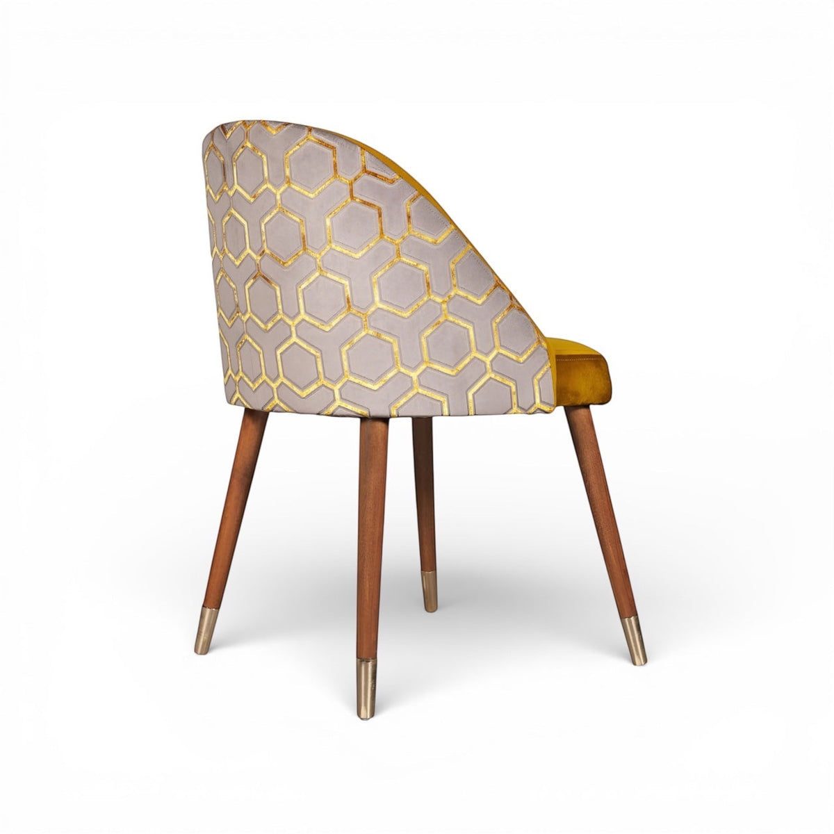 Rear angled view of the Vaya Home Alveare dining chair featuring a gray geometric patterned outer back, yellow seat upholstery, and tapered wood legs.