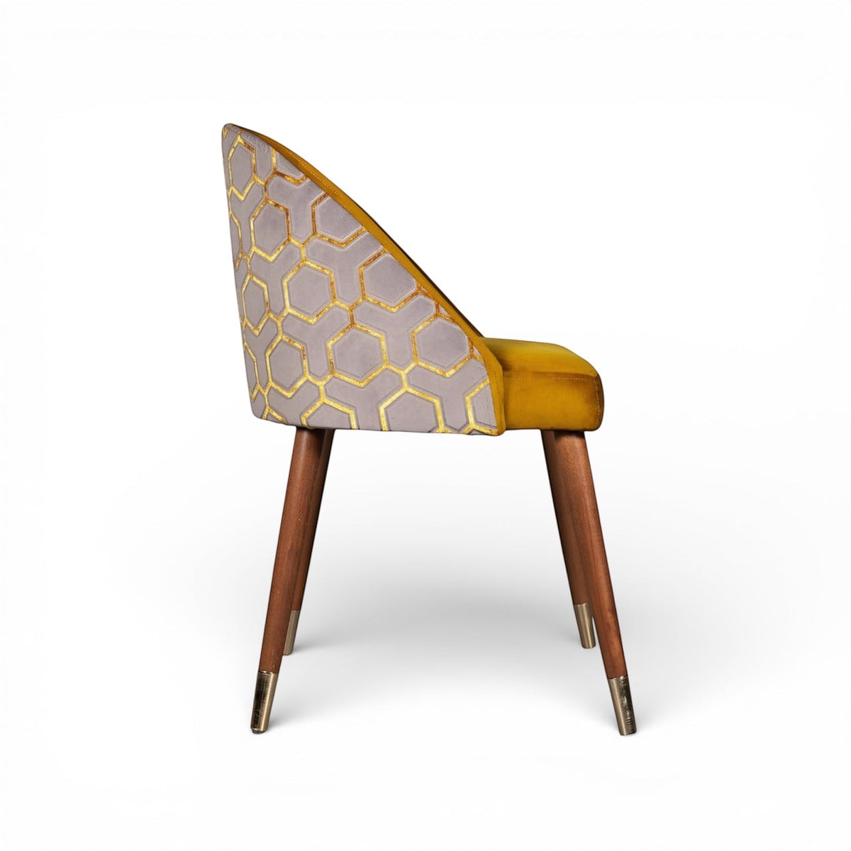Side view of the Vaya Home Alveare dining chair with yellow seat upholstery, gray geometric patterned outer back, and tapered wood legs.