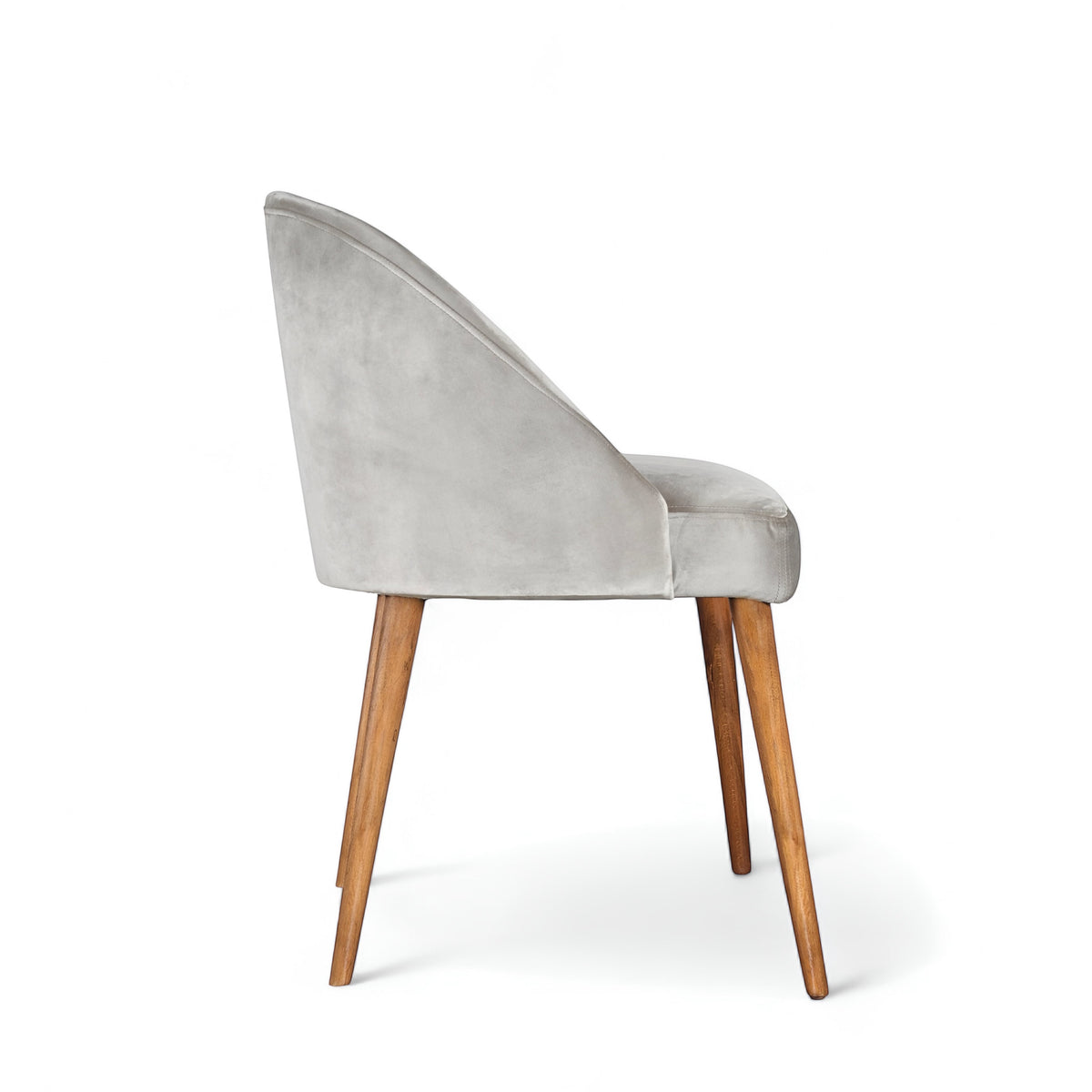 Side view of the Vaya Home Alveare dining chair featuring gray upholstery and tapered wood legs.