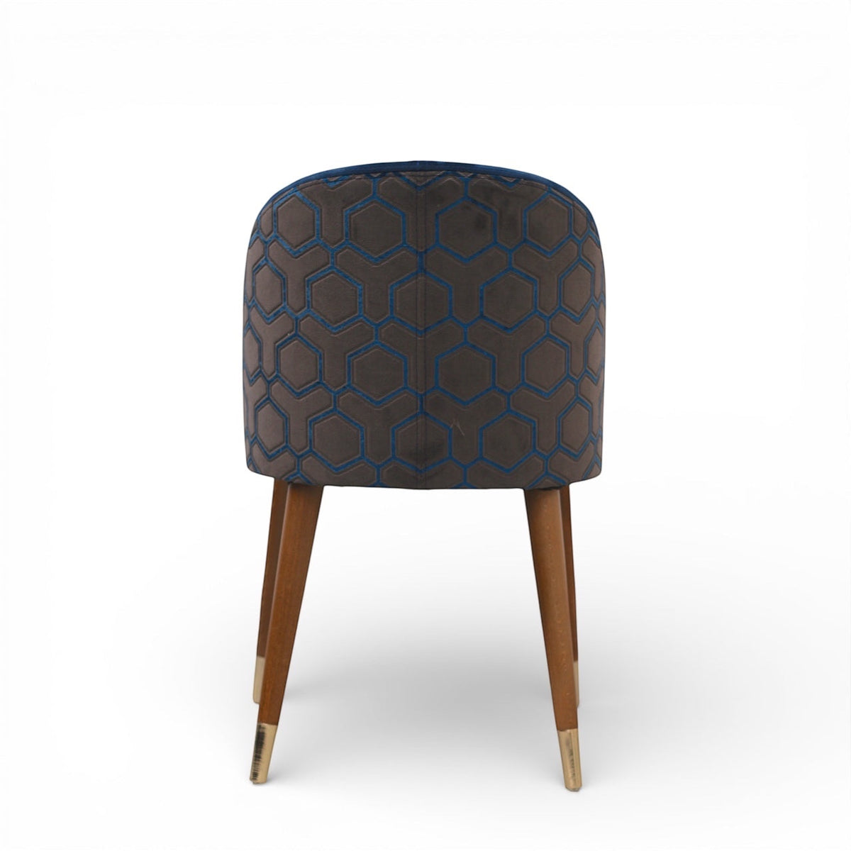 Back view of the Vaya Home Alveare dining chair featuring navy upholstery with a geometric patterned outer back and tapered wood legs.