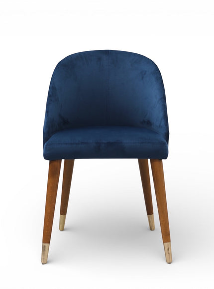 Front view of the Vaya Home Alveare dining chair with navy upholstery and tapered wood legs.