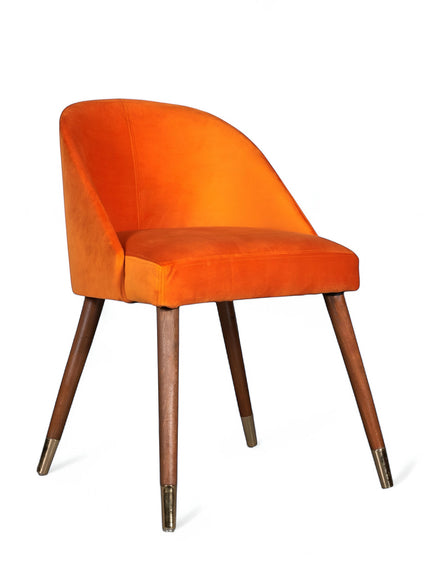 Side view of the Vaya Home Alveare dining chair featuring orange upholstery and tapered wood legs.