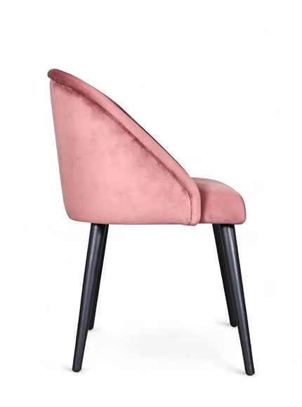 Side view of the Vaya Home Alveare dining chair with pink upholstery and black tapered legs.