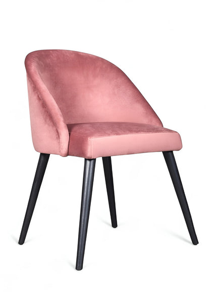 Side view of the Vaya Home Alveare dining chair with pink upholstery and black tapered legs.