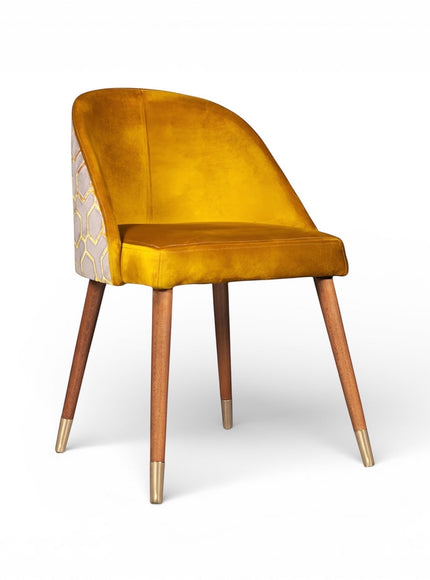Front angled view of the Vaya Home Alveare dining chair with yellow upholstery and tapered wood legs.