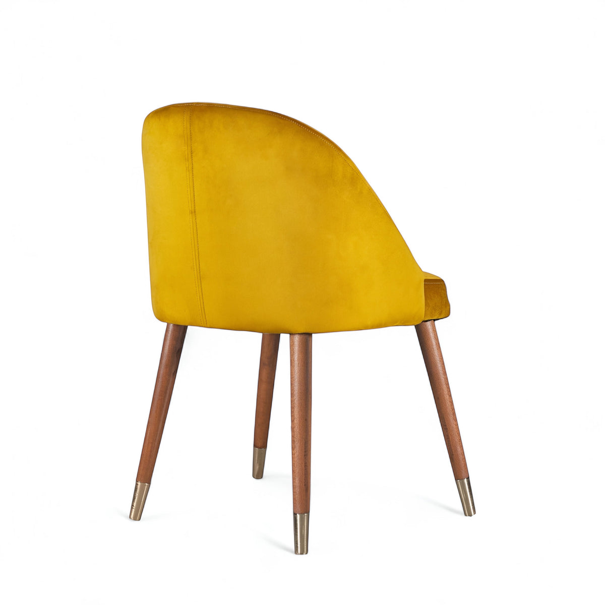 Rear angled view of the Vaya Home Alveare dining chair with yellow upholstery and tapered wood legs.