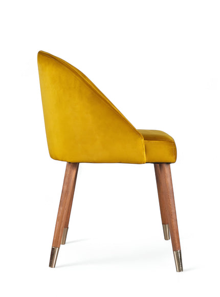 Side view of the Vaya Home Alveare dining chair featuring yellow upholstery and tapered wood legs.
