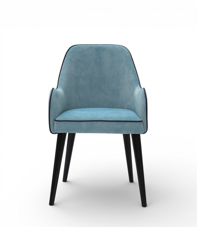 Front view of the Vaya Home Alven dining chair featuring blue upholstery, slim armrests, and black legs.