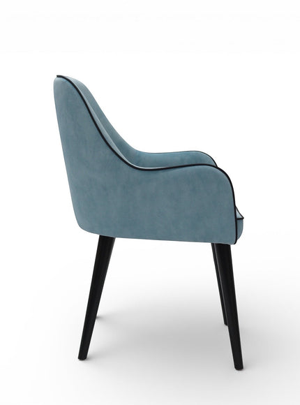 Side view of the Vaya Home Alven dining chair showing blue upholstery, curved arm detail, and black tapered legs.