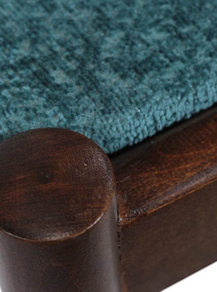 Close-up of the Vaya Home Angolo dining chair showing blue upholstery and dark wood frame detail.