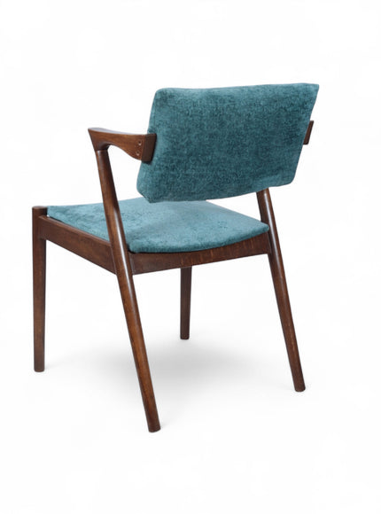 Opposite rear angled view of the Vaya Home Angolo dining chair with blue upholstery and a dark wood frame.