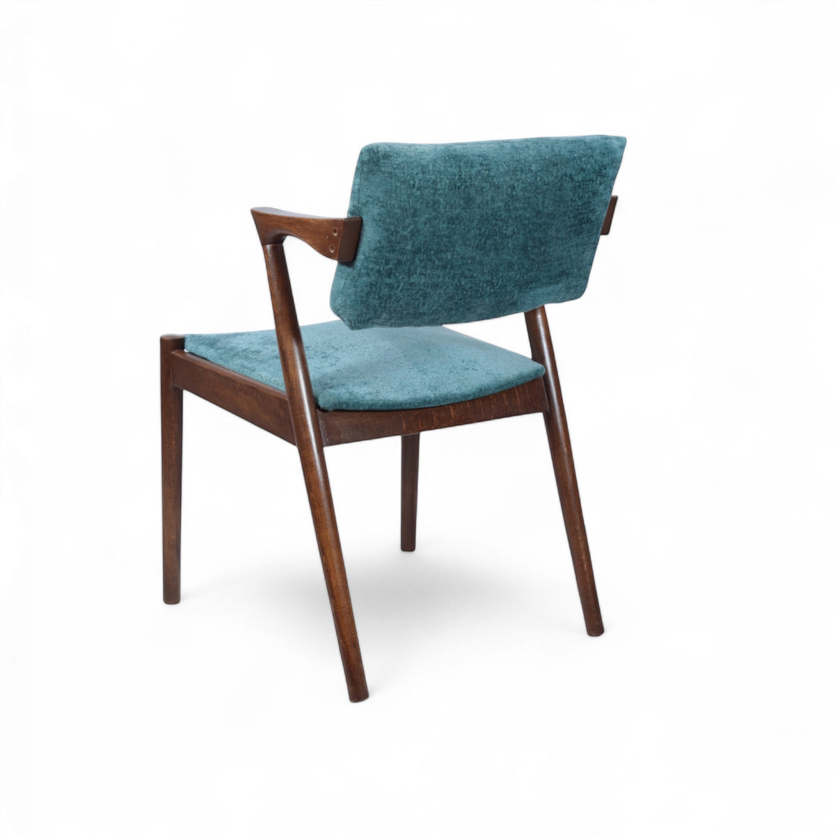 Opposite rear angled view of the Vaya Home Angolo dining chair with blue upholstery and a dark wood frame.