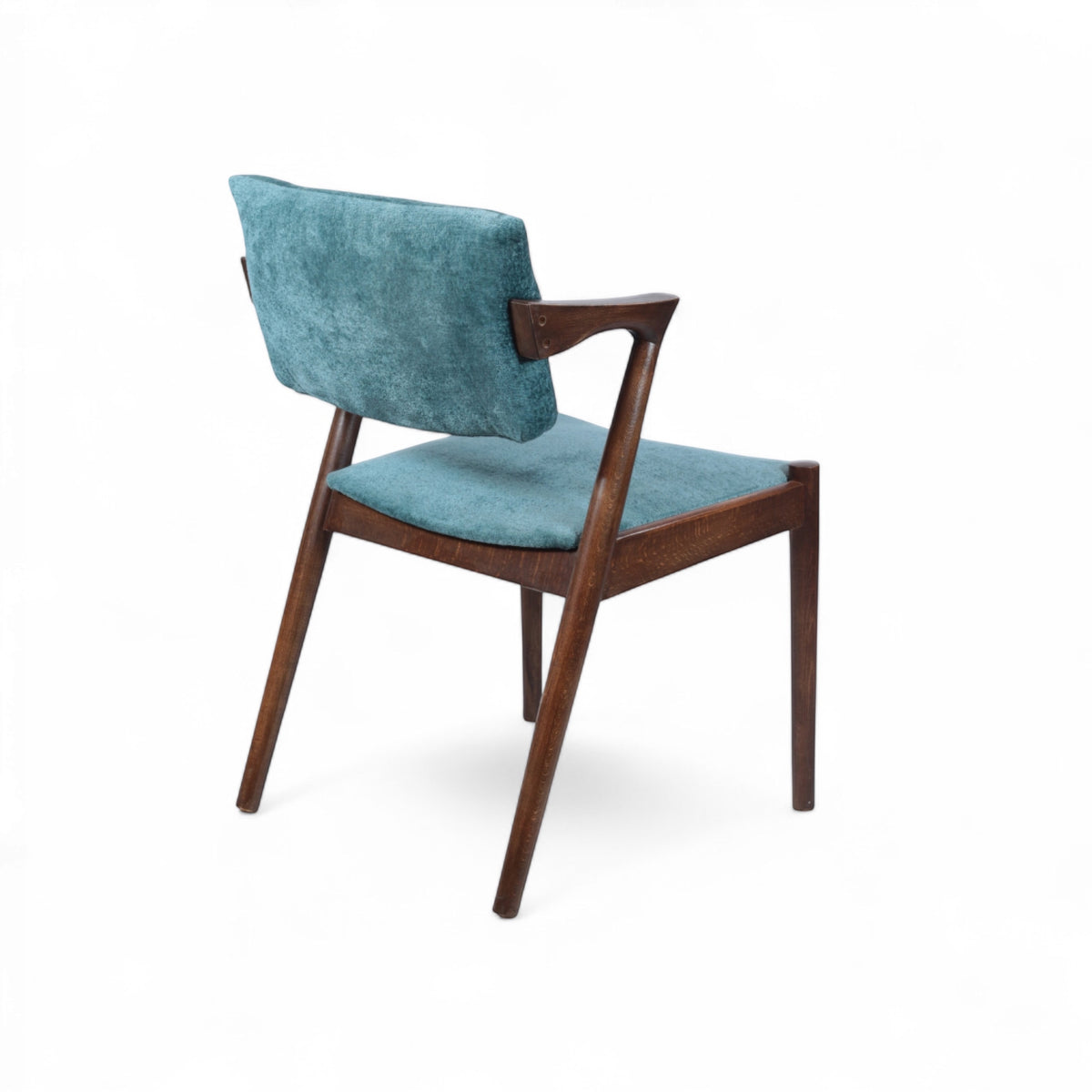 Rear angled view of the Vaya Home Angolo dining chair featuring blue upholstery, angled wood arms, and a dark wood frame.