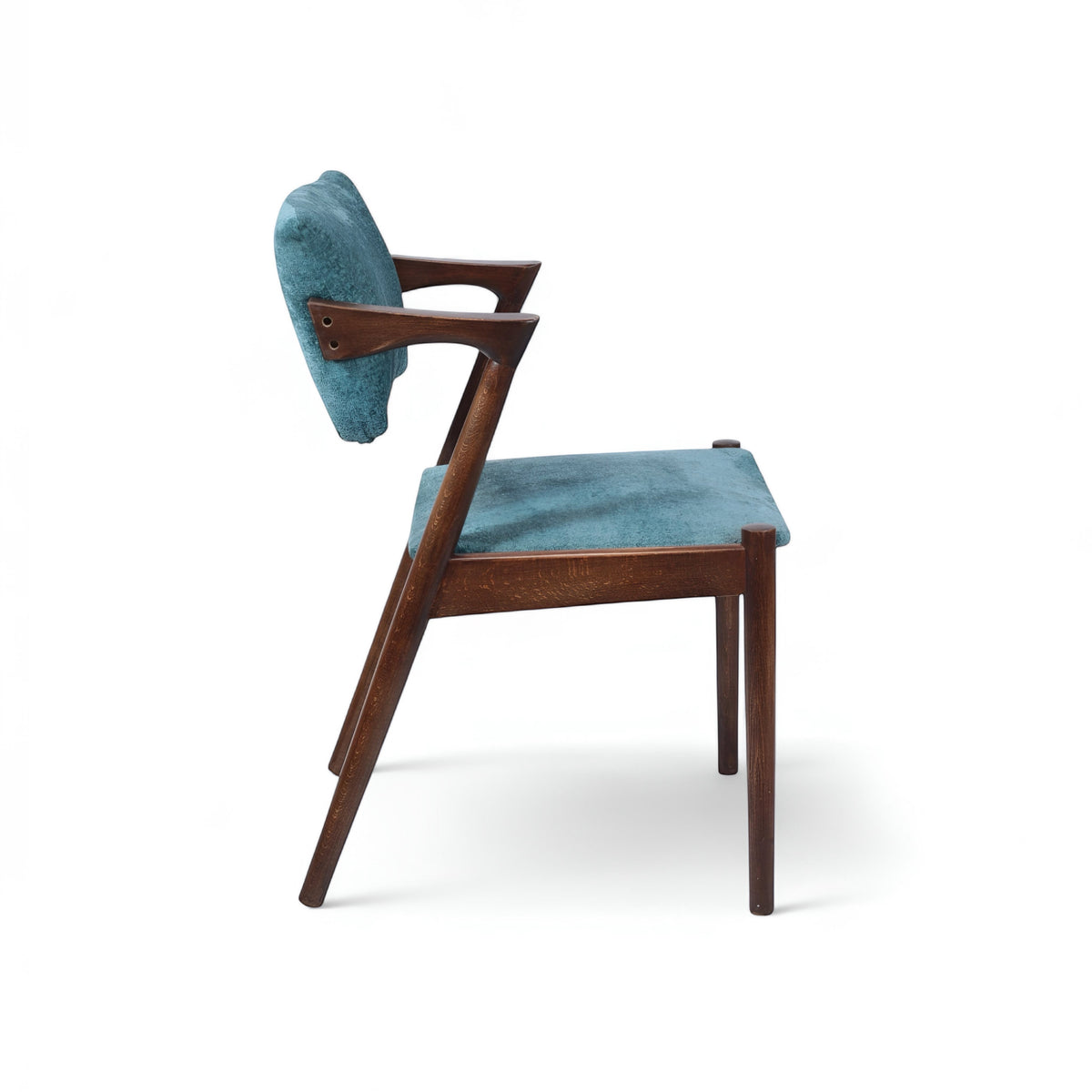 Side view of the Vaya Home Angolo dining chair with blue upholstery, angled wood arms, and a dark wood frame.