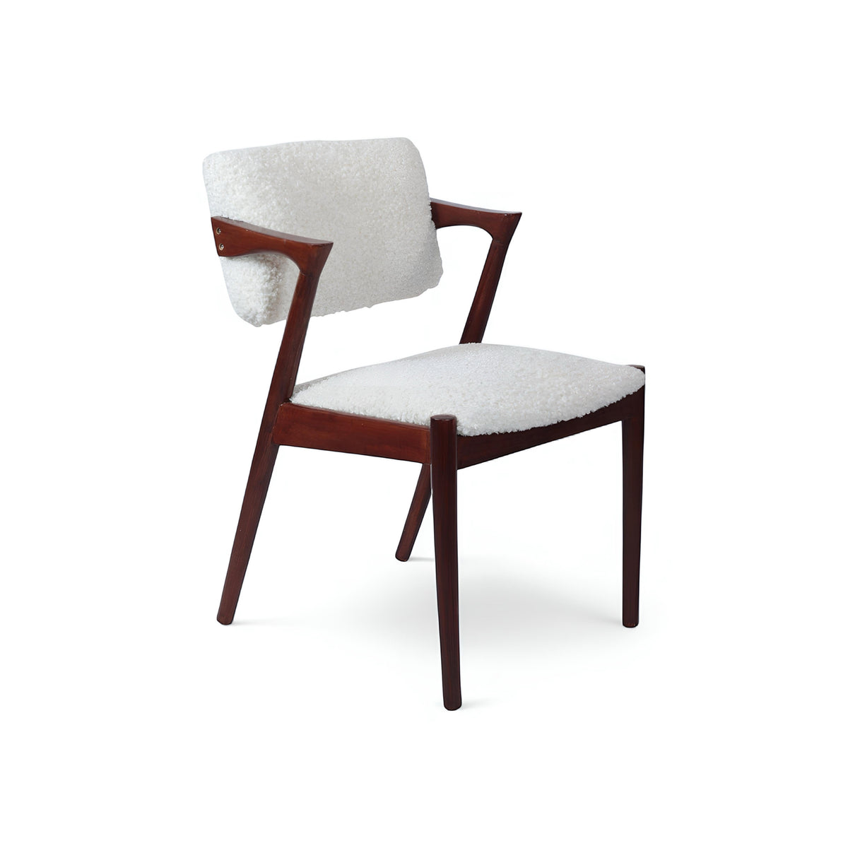 Front view of the Vaya Home Angolo dining chair with white boucle upholstery, sculpted arms, and a dark wood frame.