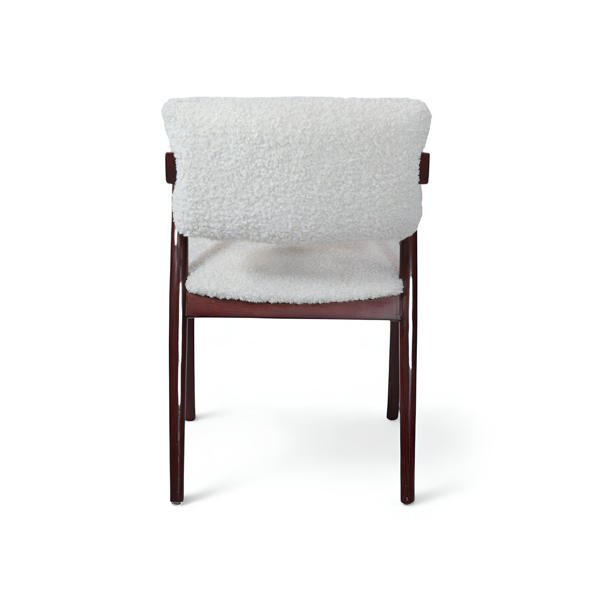 Opposite side view of the Vaya Home Angolo dining chair featuring white boucle upholstery, angled wood arms, and a dark wood frame.
