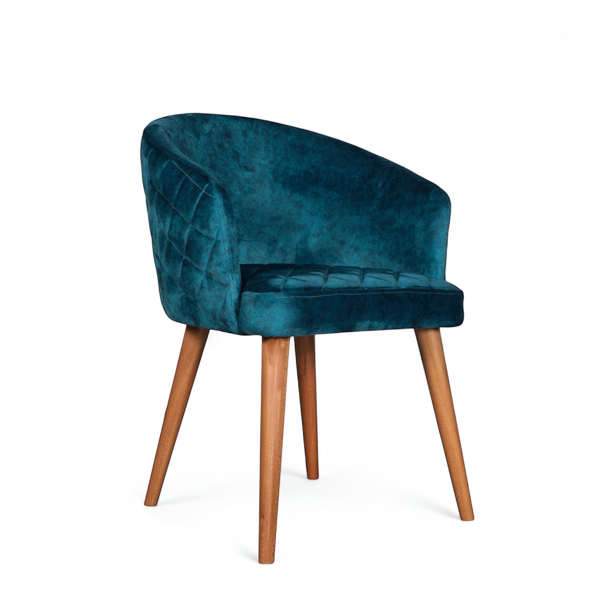 Front angled view of the Vaya Home Antigo dining chair with blue velvet upholstery, curved barrel back, and tapered wood legs.