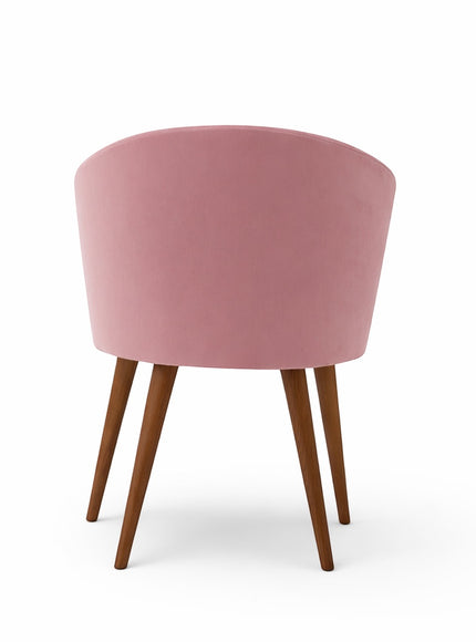 Back view of the Vaya Home Antigo dining chair featuring pink velvet upholstery and tapered wood legs.
