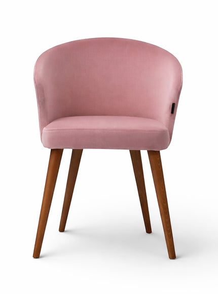 Front view of the Vaya Home Antigo dining chair with pink velvet upholstery, rounded barrel back, and tapered wood legs.