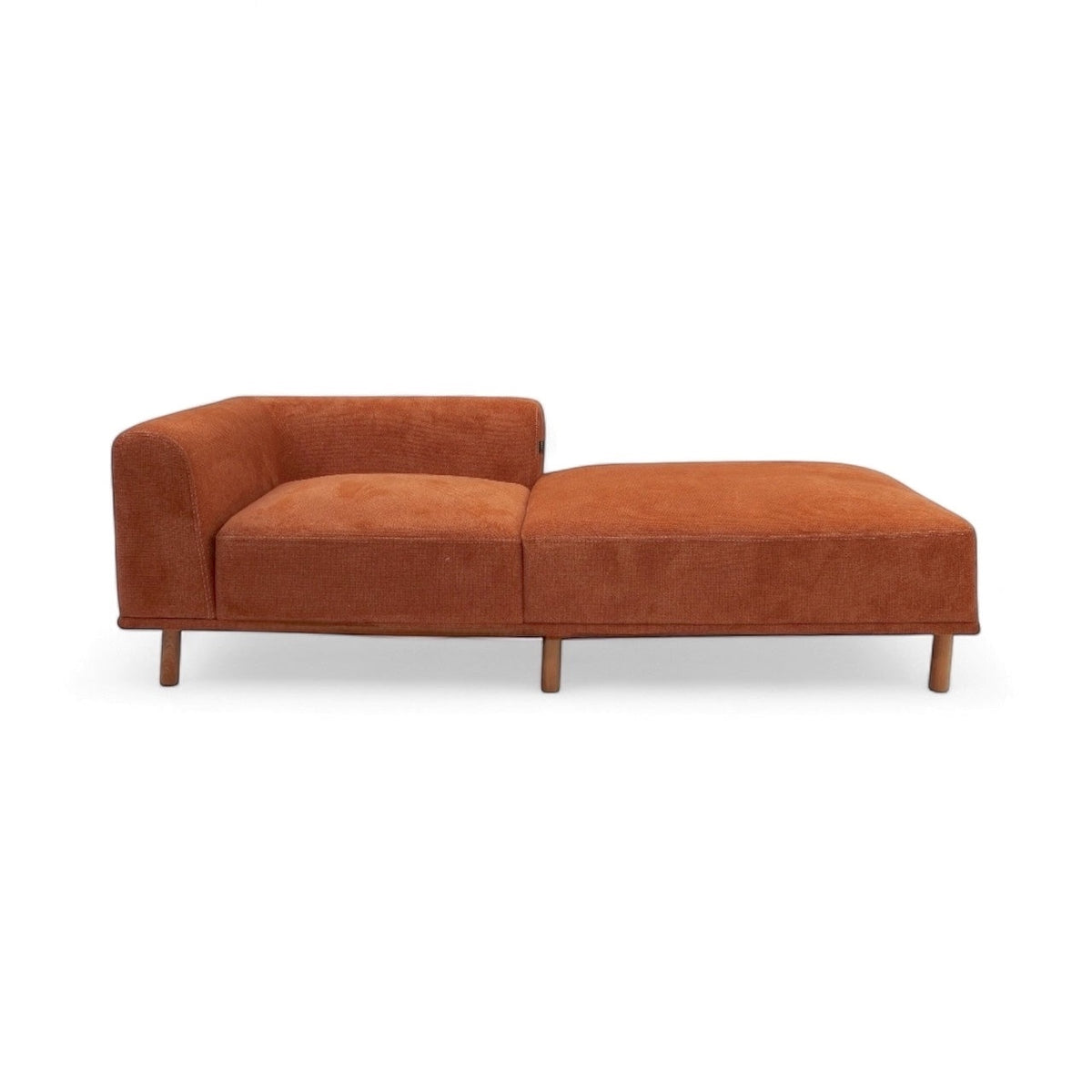 Front view of the Vaya Home Arancio lounge module in rust orange upholstery with chaise extension.