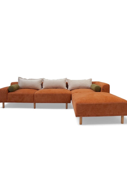 Front angled view of the Vaya Home Arancio modular sectional sofa in rust orange upholstery with chaise configuration.
