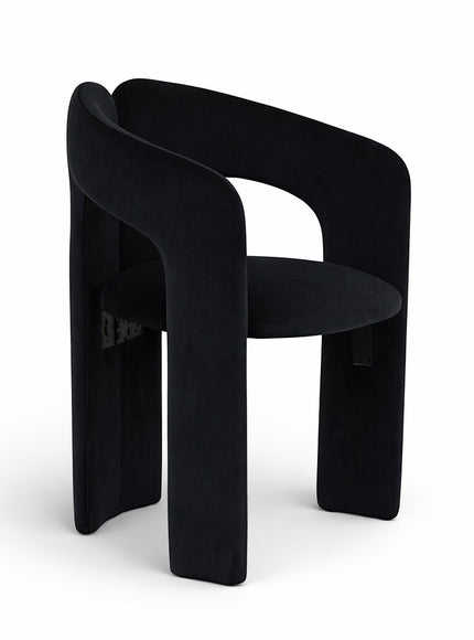 Angled front view of the Vaya Home Arcadia accent chair with black upholstery, curved arms, and an architectural silhouette.