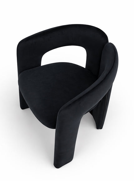Rear angled view of the Vaya Home Arcadia accent chair featuring a curved black upholstered frame and rounded seat.