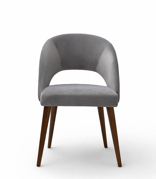 Front view of the Vaya Home Argent dining chair featuring grey upholstery, an open curved back, and tapered wood legs.