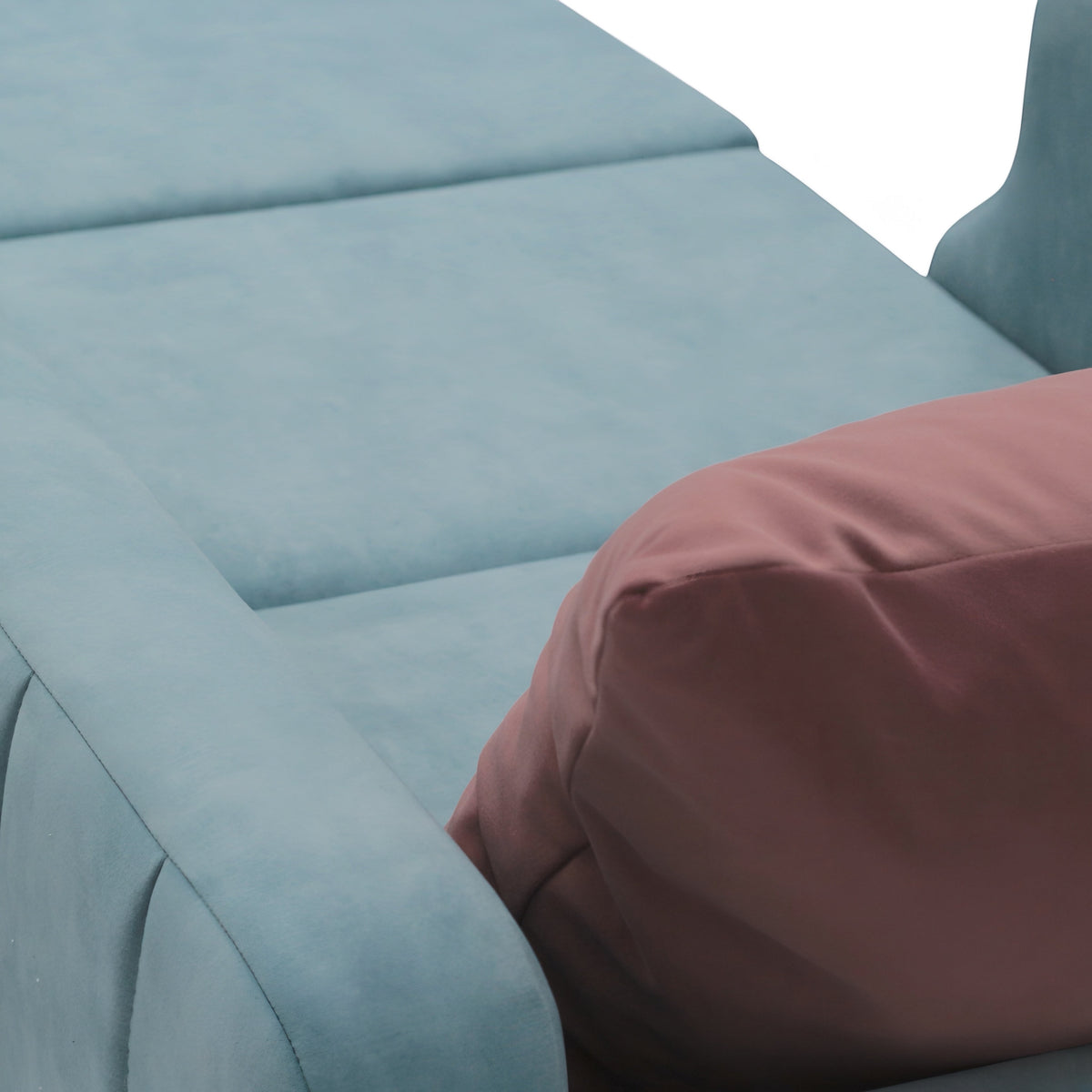 Close-up of the Vaya Home Aristo chair bed showing blue upholstery and pink accent cushion detail.
