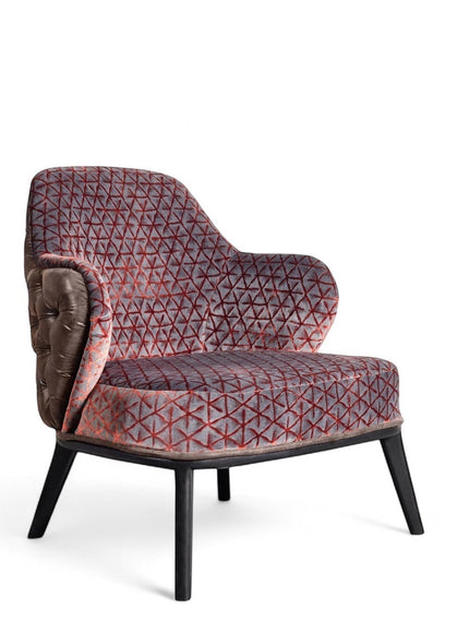 Front angled view of the Vaya Home Array accent chair with geometric patterned upholstery, curved arms, and black legs.