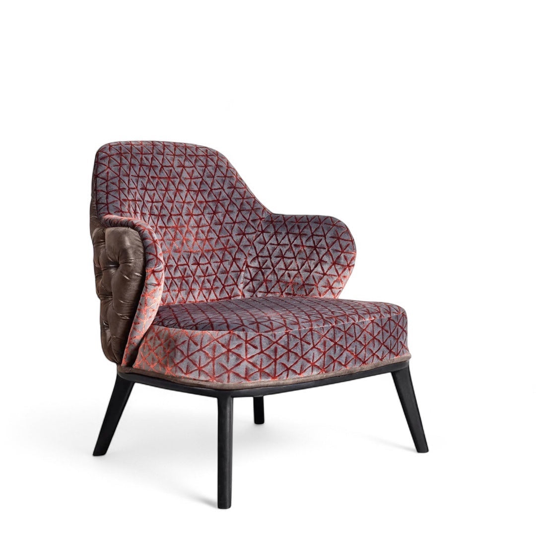 Front angled view of the Vaya Home Array accent chair with geometric patterned upholstery, curved arms, and black legs.